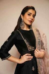 Cropped black pants and an all-black kurta with a red bandhani ajrakh dupatta